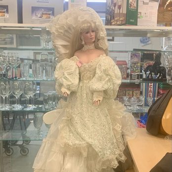 Thrift Center Thrift Store - The doll in the front capturing attention. - Thrift Stores Near Me - San Carlos, California
