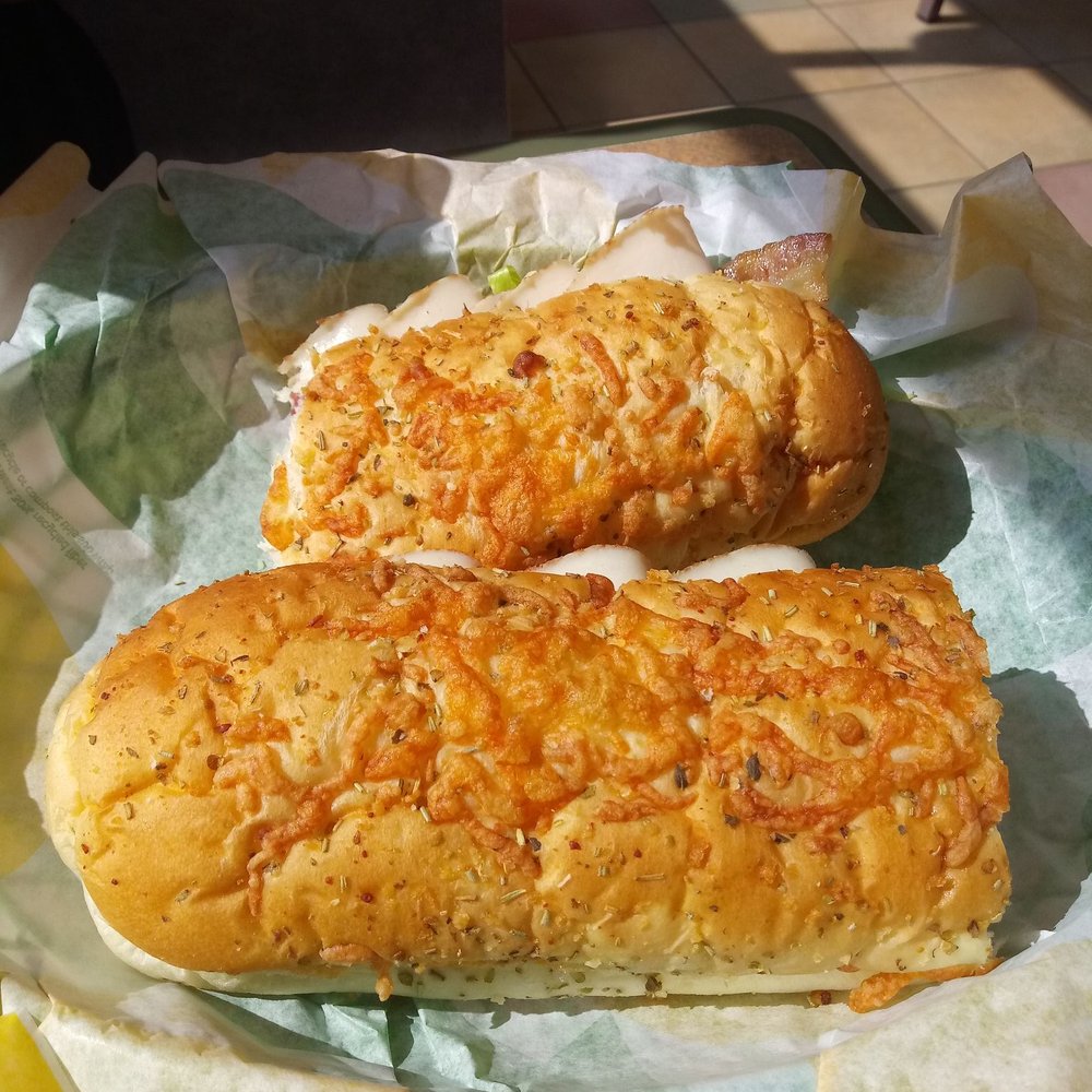 Subway - two sub sandwiches on a plate on a table - Fast Food Near Me - Sloan, Iowa Subway - two sub sandwiches on a plate on a table - Fast Food Near Me - Sloan, Iowa