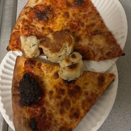 Pizza was burnt on top and on the bottom.