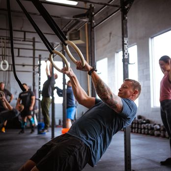 Boise CrossFit - Modifications for every movement are provided in class! Here we have a ring row being demonstrated instead of a pull-up. - Interval Training Gyms Near Me - Boise, Idaho Boise CrossFit - Modifications for every movement are provided in class! Here we have a ring row being demonstrated instead of a pull-up. - Interval Training Gyms Near Me - Boise, Idaho