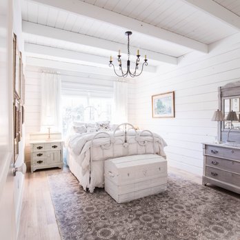 OaKline Floors - a bedroom with a bed, dresser, and mirror - Flooring Near Me - Fort Worth, Texas