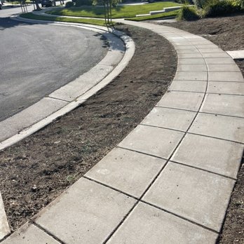 The Lawn Guys - a sidewalk and a sidewalk in a residential area - Lawn Services Near Me The Lawn Guys - a sidewalk and a sidewalk in a residential area - Lawn Services Near Me