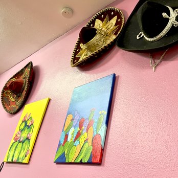 Los Compas Mexican Restaurant - a pink wall with paintings and hats on it - Mexican Near Me - Canon City, Colorado Los Compas Mexican Restaurant - a pink wall with paintings and hats on it - Mexican Near Me - Canon City, Colorado