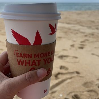 Wawa - a person holding a cup of coffee on the beach - Convenience Stores Near Me - Ocean City, Maryland Wawa - a person holding a cup of coffee on the beach - Convenience Stores Near Me - Ocean City, Maryland