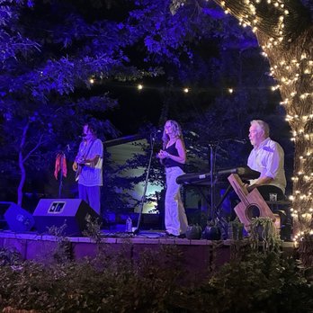 The Wyldwood - Walt and Tina Wilkins and Roy Flint singing and playing on the deck. - Music Venues Near Me The Wyldwood - Walt and Tina Wilkins and Roy Flint singing and playing on the deck. - Music Venues Near Me