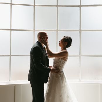 The Richland - A dramatic, editorial silhouette of the couple's first kiss in front of the venue's signature floor-to-ceiling grid window. - Hotels Near Me - Orange, California The Richland - A dramatic, editorial silhouette of the couple's first kiss in front of the venue's signature floor-to-ceiling grid window. - Hotels Near Me - Orange, California