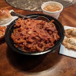 Spicy Pork Bowl with dumplings and kimchi, a side of curry vegetables, and a soft bread roll Spicy Pork Bowl with dumplings and kimchi, a side of curry vegetables, and a soft bread roll