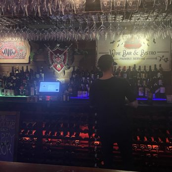 Dracula's Legacy Wine Bar - The bar area with a long array of hung glasses - Wine Bars Near Me - St. Petersburg, Florida