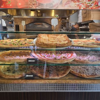 Savas - a display of pizzas in a restaurant - Pizza Near Me - Philadelphia, Pennsylvania Savas - a display of pizzas in a restaurant - Pizza Near Me - Philadelphia, Pennsylvania