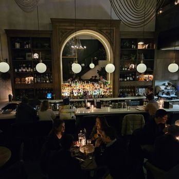 The Watson - a group of people sitting at a bar - Cocktail Bars Near Me - Vancouver, British Columbia