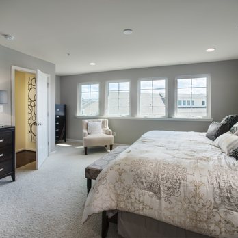 LC Homes DE - a bedroom with a large bed and a dresser - Real Estate Services Near Me - Claymont, Delaware LC Homes DE - a bedroom with a large bed and a dresser - Real Estate Services Near Me - Claymont, Delaware
