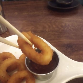 Big Bird Sushi Bar & Thai - Closeup using chopstick dipping the calamari and US yeah thaibsweet and salad sauce - Thai Near Me - Chicago, Illinois Big Bird Sushi Bar & Thai - Closeup using chopstick dipping the calamari and US yeah thaibsweet and salad sauce - Thai Near Me - Chicago, Illinois