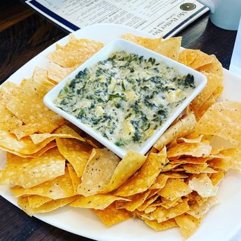 Mo' Brunch & Brews - Spinach and artichoke dip with seasoned tortilla chips - Breakfast & Brunch Near Me - Houston, Texas Mo' Brunch & Brews - Spinach and artichoke dip with seasoned tortilla chips - Breakfast & Brunch Near Me - Houston, Texas