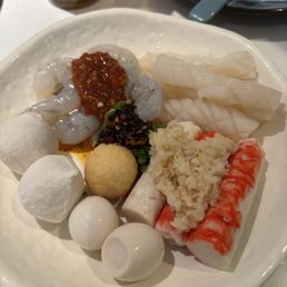 Assorted seafood for my hot pot with chili oil and chili sauce and two quail eggs - Delicious Assorted seafood for my hot pot with chili oil and chili sauce and two quail eggs - Delicious