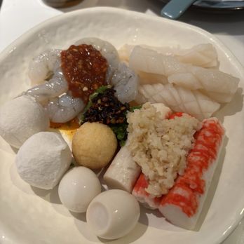 Happy Lamb Hot Pot - Assorted seafood for my hot pot with chili oil and chili sauce and two quail eggs - Delicious - Chinese Near Me - Austin, Texas Happy Lamb Hot Pot - Assorted seafood for my hot pot with chili oil and chili sauce and two quail eggs - Delicious - Chinese Near Me - Austin, Texas