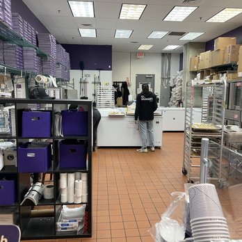 Insomnia Cookies - a bakery kitchen with workers in the background - Desserts Near Me - Atlanta, Georgia Insomnia Cookies - a bakery kitchen with workers in the background - Desserts Near Me - Atlanta, Georgia