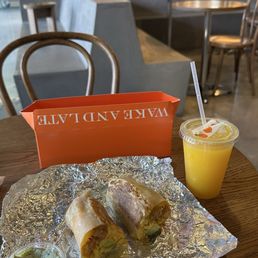Breakfast burrito and Orange Juice Breakfast burrito and Orange Juice