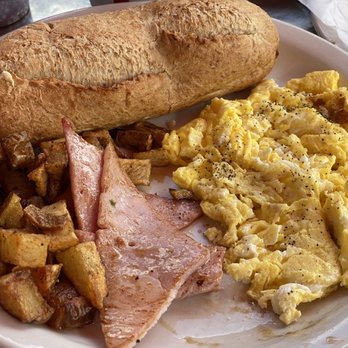 Gauchos Gourmet Market - Scrambled eggs with a side of ham and their home potatoes. Whole wheat baguette toasted to perfection. - Argentine Near Me - Miami, Florida Gauchos Gourmet Market - Scrambled eggs with a side of ham and their home potatoes. Whole wheat baguette toasted to perfection. - Argentine Near Me - Miami, Florida