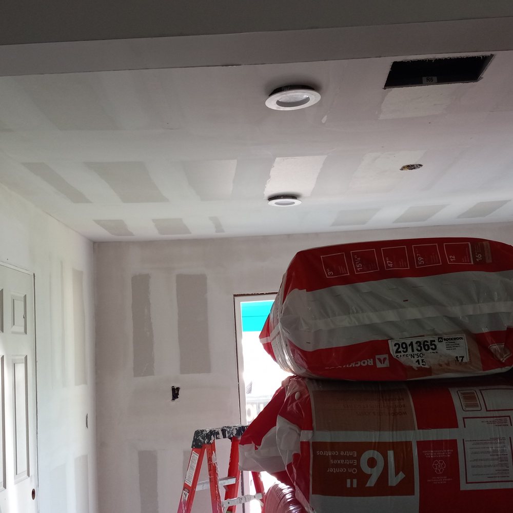 Simon Painting & Remodeling - a room with white walls and a ladder - Painters Near Me Simon Painting & Remodeling - a room with white walls and a ladder - Painters Near Me