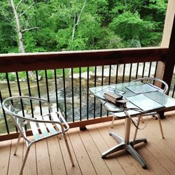 Chez Josephine - Deck seating on Roaring River by reminets of old mill.