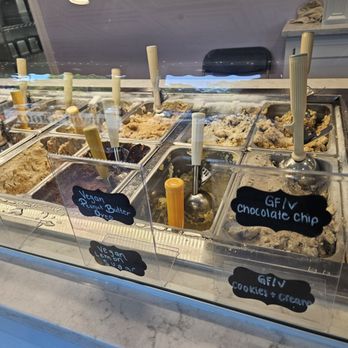 Sweet Sensations - Multiple ice cream flavors are shown behind a glass display at Sweet Sensations in Geneva, IL, with handwritten labels for various flavors. - Desserts Near Me - Geneva, Illinois