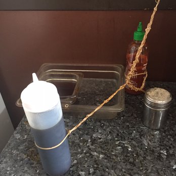 Dim Sum King - I bottle on water-downed cold soy sauce that is tethered down to the wall. - Dim Sum Near Me - Seattle, Washington Dim Sum King - I bottle on water-downed cold soy sauce that is tethered down to the wall. - Dim Sum Near Me - Seattle, Washington