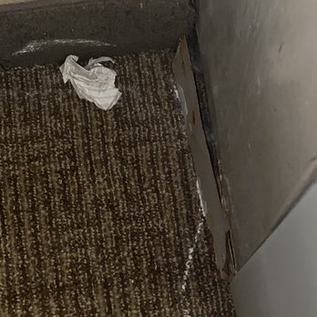Comfort Inn University Area - Trash and white stuff on the carpet by the air conditioning unit. - Hotels Near Me - Baton Rouge, Louisiana