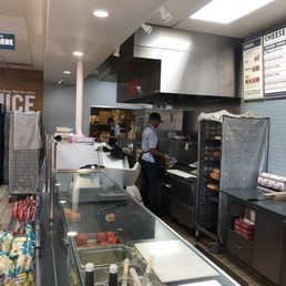 Kid in the back on his cell phone while customers wait.