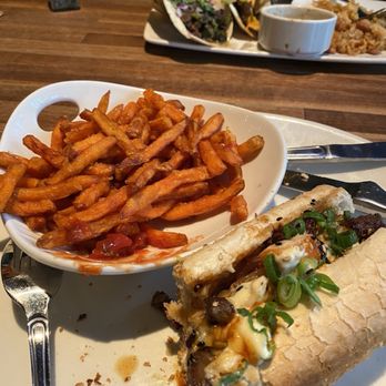 Yard House - Korean Beef Cheesesteak with Sweet Potato Fries. - Bars Near Me - Hallandale Beach, Florida Yard House - Korean Beef Cheesesteak with Sweet Potato Fries. - Bars Near Me - Hallandale Beach, Florida