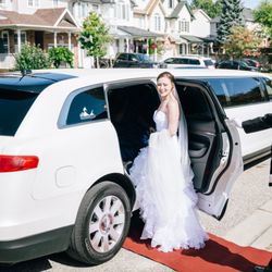 Brentwood Livery - Chauffeur holding the door for the bride