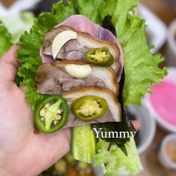 So Moon Nan Jokbal - a hand holding a sandwich - Korean Near Me - Garden Grove, California