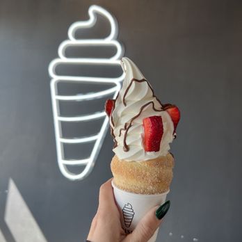 Crispy Cones - a hand holding an ice cream cone - Desserts Near Me - Rexburg, Idaho