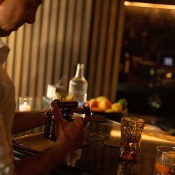 El Vecino - a bartender pouring a drink at a bar - Cigar Bars Near Me - Miami, Florida El Vecino - a bartender pouring a drink at a bar - Cigar Bars Near Me - Miami, Florida