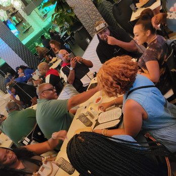 Spark it Up Crawl - a group of people sitting at a table - Bar Crawl Near Me Spark it Up Crawl - a group of people sitting at a table - Bar Crawl Near Me