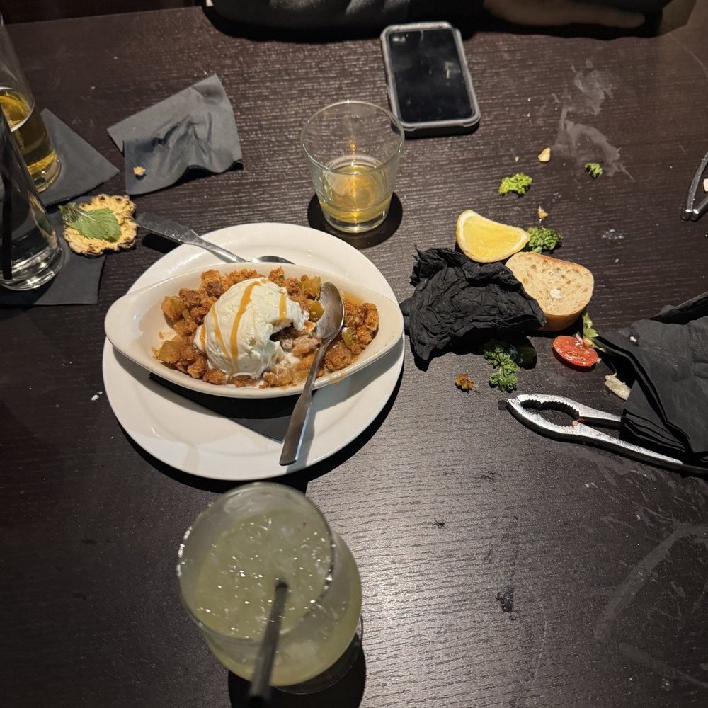 A mess left when dessert was brought over. Apple crumble dessert that was more crumble than apple.