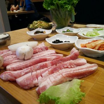 Kobi Korean BBQ - 2 servings of thick cut pork belly for BBQ. Banchan in the back. - Barbeque Near Me - Vaughan, Ontario Kobi Korean BBQ - 2 servings of thick cut pork belly for BBQ. Banchan in the back. - Barbeque Near Me - Vaughan, Ontario