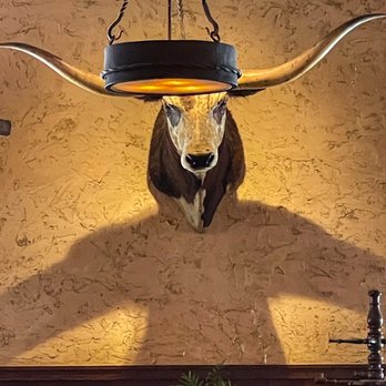 H3 Ranch - This longhorn head on the wall have shadows that made it look it have arms and a body. - Steakhouses Near Me - Fort Worth, Texas H3 Ranch - This longhorn head on the wall have shadows that made it look it have arms and a body. - Steakhouses Near Me - Fort Worth, Texas