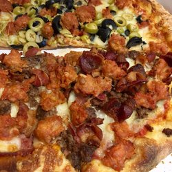 Restaurant Trevi Pizza - Meat lovers and Italian sausage & cheese. This is the cold pizza. Couldn't resist eating it before snapping a pic