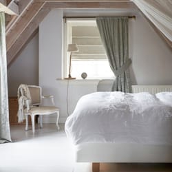 Budget Blinds of the Hamptons - Dim out a room by using blackout liner on soft fold Roman shades and rod pocket draperies.