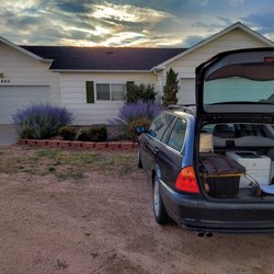 Greg the Notary Guy - Mobile notarization services full office equipment available on site blue car in front of house sunset