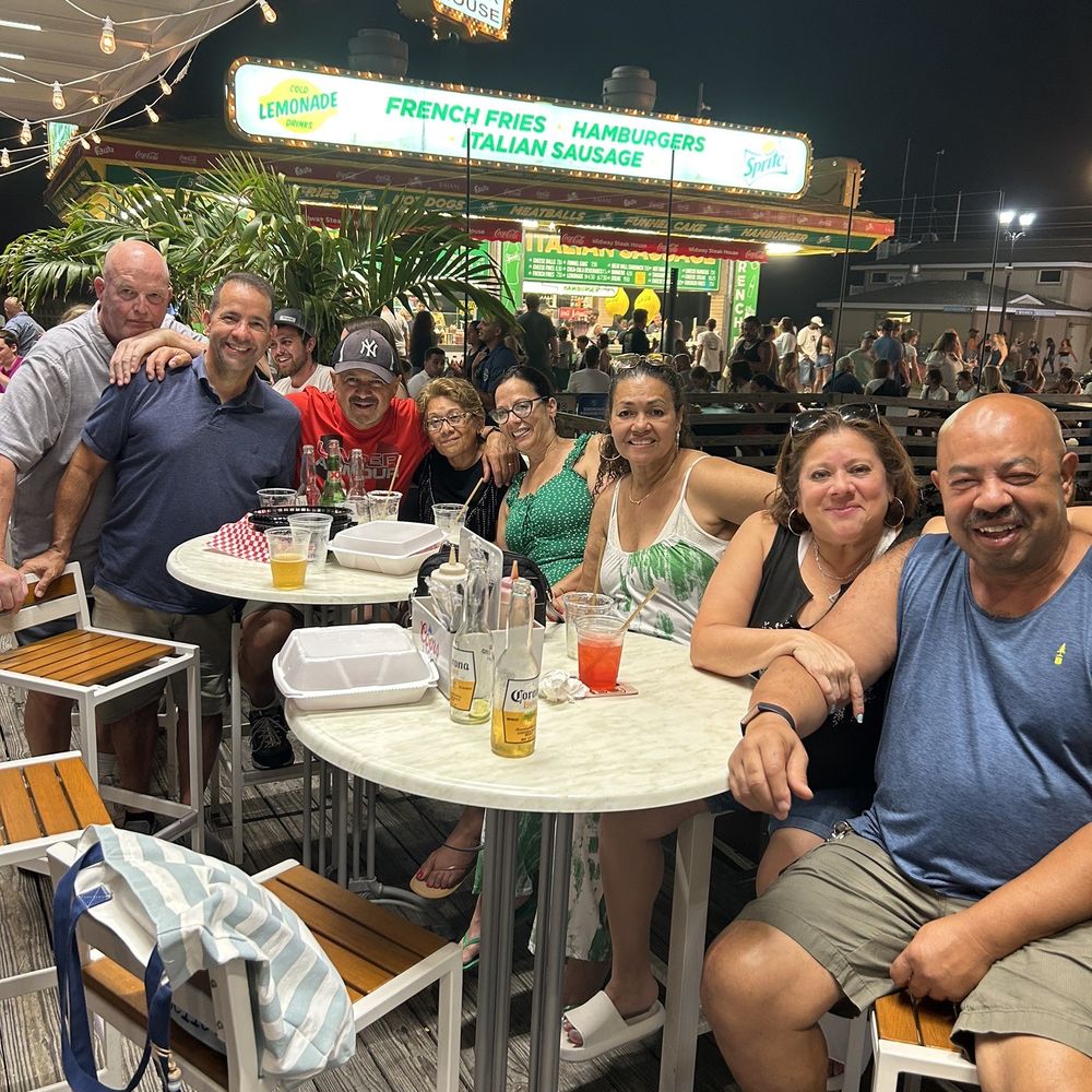 a group of people sitting around a table a group of people sitting around a table