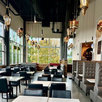 Tanoor - Spacious, tall ceilings, lantern lights, wall of windows that lift up in warm weathers, and nice views of trees tops & distant mountains. - Lebanese Near Me - Sammamish, Washington