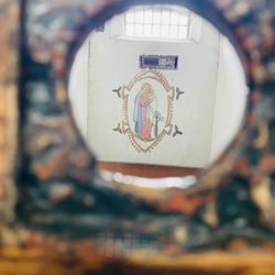 Kilmainham Gaol - The word of a slain freedom fighter used her time in this tiny prison cell to paint. Picture taken through prison guard peep hole