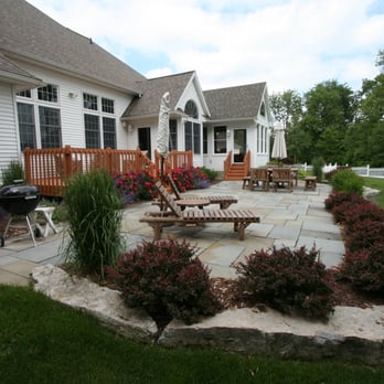 Perennial Landscaping - Bluestone patio with a limestone wall and new plantings - Landscaping Near Me - Nassau, New York Perennial Landscaping - Bluestone patio with a limestone wall and new plantings - Landscaping Near Me - Nassau, New York