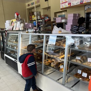 Castle Donuts - a little boy looking at a display case full of donuts - Donuts Near Me - Clearlake, California