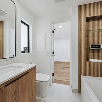 Bathroom Place - This breathtaking bathroom renovation showcases our Hudson vanities paired with Soho Mirrors. - Kitchen & Bath Near Me - Pompano Beach, Florida Bathroom Place - This breathtaking bathroom renovation showcases our Hudson vanities paired with Soho Mirrors. - Kitchen & Bath Near Me - Pompano Beach, Florida