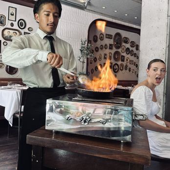 Quality Italian - Table-side flambé of our Alla Vodka sauce for our Spicy Lobster Rigatoni (love the look on the photobomb guest's face) - Italian Near Me - Denver, Colorado Quality Italian - Table-side flambé of our Alla Vodka sauce for our Spicy Lobster Rigatoni (love the look on the photobomb guest's face) - Italian Near Me - Denver, Colorado