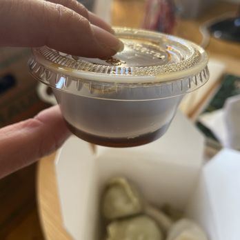 Lisa's Dumplings - a hand holding a container of dumplings - Chinese Near Me - New York, New York Lisa's Dumplings - a hand holding a container of dumplings - Chinese Near Me - New York, New York