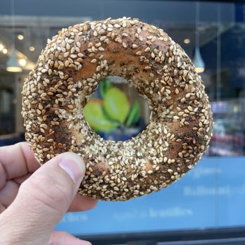 Mezzmiz - a hand holding a sesame bagel - Lebanese Near Me - Montreal, Quebec Mezzmiz - a hand holding a sesame bagel - Lebanese Near Me - Montreal, Quebec