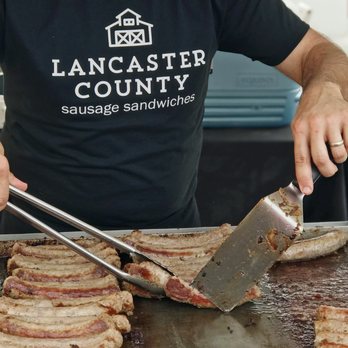 Lancaster County Sausage - a man cooking bacon on a grill - Sandwiches Near Me - Garnet Valley, Pennsylvania Lancaster County Sausage - a man cooking bacon on a grill - Sandwiches Near Me - Garnet Valley, Pennsylvania